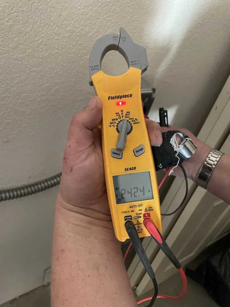 Voltage testing with clamp meter during Electrical Installation Services in Victor